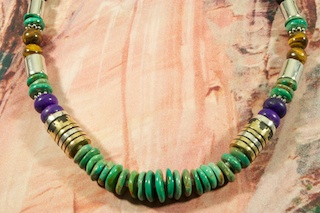 Genuine Assorted Gemstones Necklace with Sterling Silver and Gold Filled Barrels. Featuring Genuine Turquoise, Sugilite, Spiny Oyster Shell, Tiger's Eye, Black Onyx and Blue Lapis. Sterling Silver
Beads, Cones and Clasp.  Stunning Necklace Created by Navajo Artist Tommy Singer. Signed.